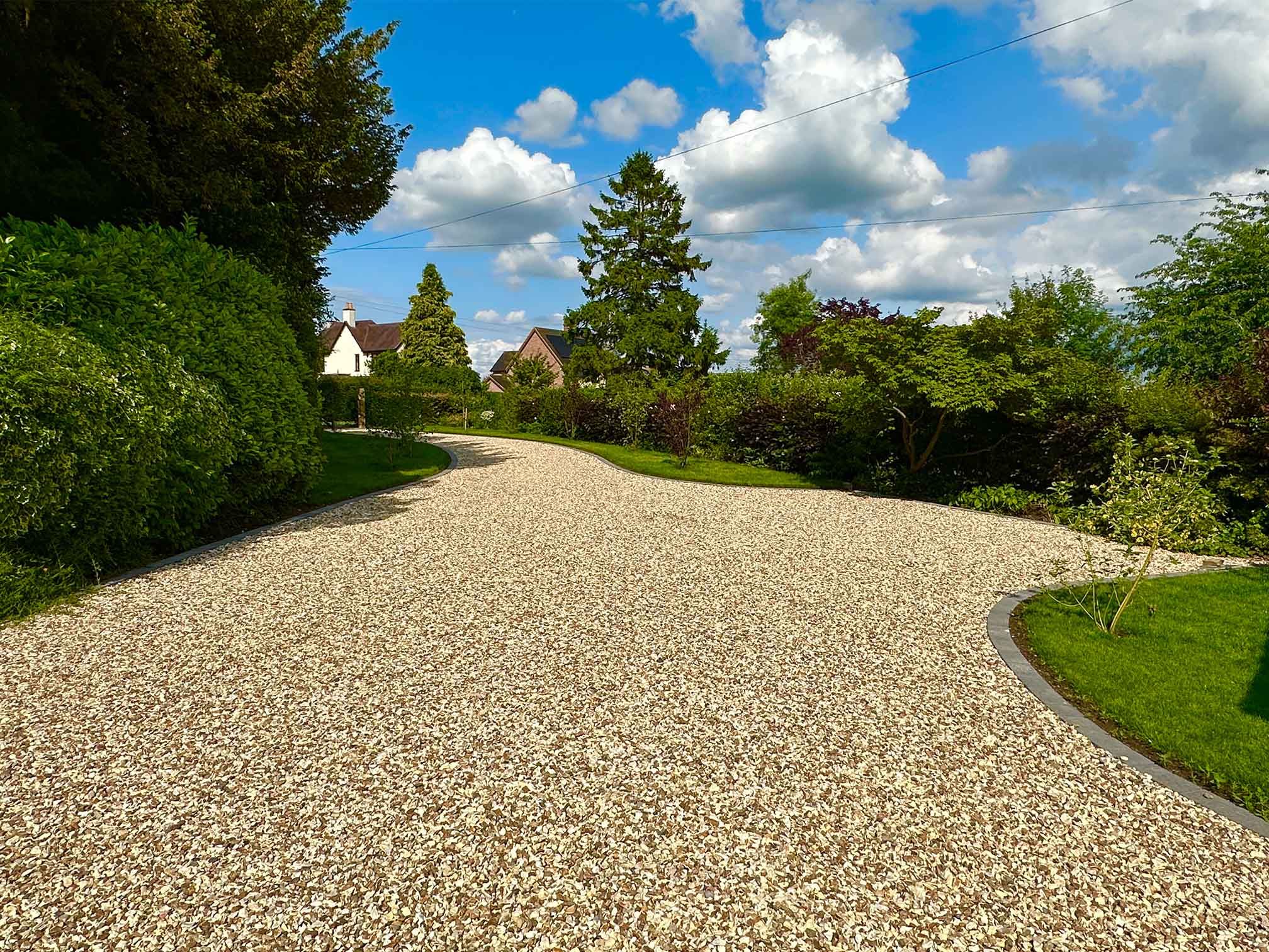A gravel driveway with a mixed pattern of stones